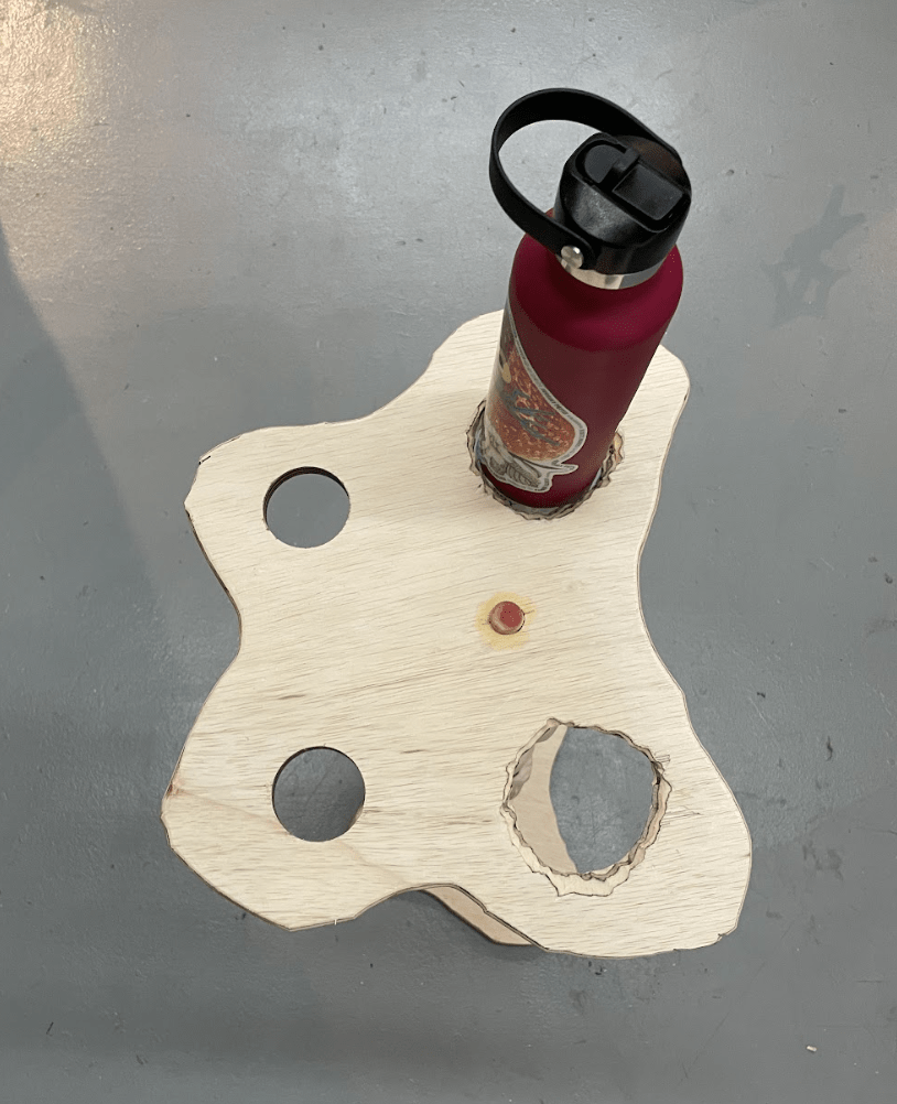 The top of the spine table, shaped like a pelvis, holding my pink water bottle